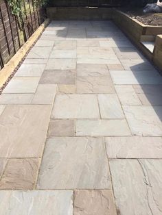 a stone walkway in the middle of a garden