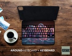 there is a keyboard and mouse on the table next to a cup of coffee with pictures around it