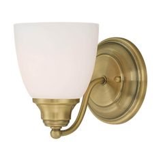 a wall light with a white glass shade