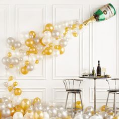 a party with balloons and champagne bottles