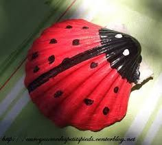 a lady bug umbrella sitting on top of a green and white striped surface with black dots