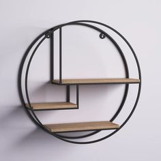 a circular metal shelf with wooden shelves in the shape of a circle on a white wall