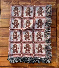 a blanket with monkeys on it sitting on a wooden floor