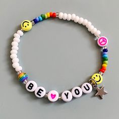 Made using the highest quality solid colour seed beads. The large white beads are 4mm and the smaller rainbow ones are 3mm. Also featuring 7mm acrylic letter, heart, smiley and peace beads.  Finished with a cute stainless steel steel star. Elasticated on a strong cord. Can be personalised with any name or word. Available in 5 sizes. Customizable Fun White Jewelry, Fun Customizable White Jewelry, White Beaded Bracelets With Round Beads, Trendy White Beads For Friendship, Fun White Jewelry With Letter Beads, White Smiley Face Round Bead Bracelets, Customized White Trendy Beaded Bracelets, Customized Playful White Jewelry, Trendy White Beaded Bracelets With Smiley Face