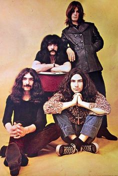 the band aeroid posing for a photo in front of a yellow background with their arms crossed