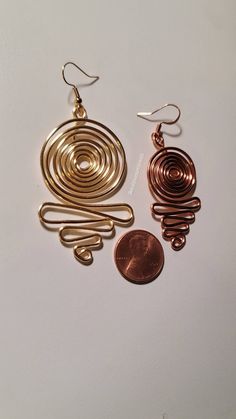 Beautiful 16 gage hammered copper wire wrapped spiral earrings -All pieces are made with top quality tarnish resistant copper wire. Why copper? Copper is a conductor of energy and works wonders when paired with healing crystals. Copper has healing properties itself. For example, not only is it a natural and necessary agent found in the body but it aids in mineral absorption, helps with arthritis, has anti-inflammatory and great anti-aging properties. Most importantly is help with proper immune f Gold Spiral Earrings Made Of Copper, Copper Spiral Wire Wrapped Earrings, Wire Wrapped Spiral Copper Earrings, Wire Wrapped Copper Spiral Earrings, Spiral Copper Wire Jewelry With Ear Wire, Nickel-free Spiral Copper Jewelry, Hand Forged Copper Spiral Earrings, Cooper Jewelry, Hammered Copper Earrings