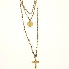 The brilliance of this necklace comes from the sparkling faceted pyrite beads on an antique gold chain. The grandeur of this three-tiered necklace arises from the cast bronze medal and coordinating cross pendant. The reverse side of the cross medal says, 'GOD is our refuge and strength, a very present help in trouble.' (Psalm 46:1) This length of this piece is adjustable from 29-32 inches and the cross measures 1.5 inches long. The splendor and nobility of God is rich and everlasting, and by rec Bronze Brass Cross Necklace, Bronze Crucifix Necklace For Spiritual Purposes, Spiritual Bronze Crucifix Necklace, Antique Brass Cross Pendant Necklace, Antique Bronze Cross Necklace, Spiritual Cross Necklace With Antique Finish, Spiritual Cross Necklaces With Antique Finish, Gold Necklace With Oxidized Cross Pendant, Gold Oxidized Cross Jewelry