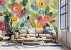 a living room with flowers painted on the wall