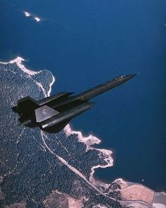 an air force jet flying over land and water