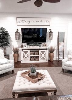 a living room filled with furniture and a flat screen tv mounted on the wall above it