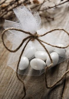 some white balls are tied up on a piece of wood