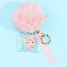 a pink pom - pom keychain with an animal on it