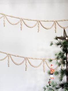 a christmas tree with ornaments hanging from it's branches and lights on the top