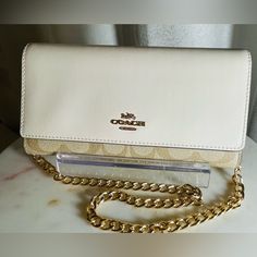 Beautiful Cream And Tan Leather Coach. Has Many Card Slots And Zippered Pouches Comes With Dust Bag And Shoulder Chain Strap.Nwot Coach Luxury Clutch For Everyday, Classic Gold Bifold Bag, Coach Wallets With Chain Strap For Everyday Use, Coach Crossbody Wallet With Detachable Strap, Coach Wallet On Chain For Everyday Use, Coach Rectangular Wallet On Chain For Everyday Use, Coach Rectangular Chain Wallet With Detachable Strap, Coach Gold Wallet For Everyday Use, Coach Crossbody Wallet For Travel