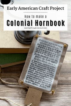 an old book with the title how to make a colonial hornbook, on top of a wooden table