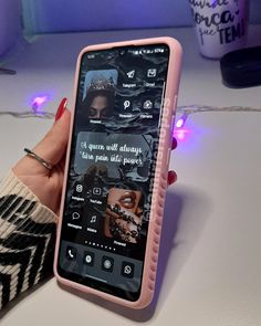 a person holding up a pink cell phone with pictures on the screen and texting