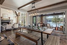 the dining room table is set with place settings for six people and has an open fireplace