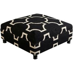 a black and white ottoman sitting on top of a wooden table