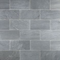 a close up view of a gray tile wall