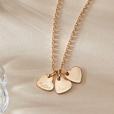 A neverending love story, our Personalized Heart Name Necklace is the perfect way to represent a growing family. Hand engrave up to 5 mini flat hearts with the names of your little ones or those you hold closest to your heart.&nbsp;18K Champagne Gold Plated, 925 Sterling Silver or 18K Rose Gold PlatedMini Flat Heart: 0.4 x 0.4Secure clasp fasteningCharms are removable from this chain and can be worn on all Merci Maman chain lengthsHand engraved in our Paris workshopSent with love in a compli Stacked Jewelry, Growing Family, Mini Heart, Champagne Gold, Personalized Necklace, Hand Engraving, Name Necklace, 18k Rose Gold, Rose Gold Plates