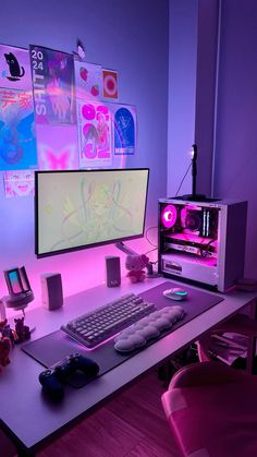 a computer desk with a keyboard, mouse and monitor on it in front of a purple wall