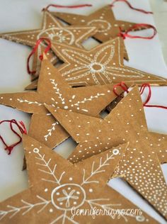 five brown star shaped ornaments with red string