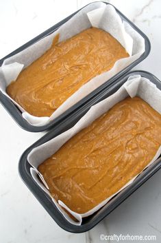 two pans filled with batter sitting on top of a counter next to each other