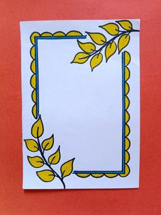 a piece of paper with yellow leaves on it and a blue border around the corner