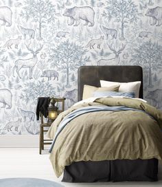 a bed in a room with a wallpapered animal pattern on the wall behind it