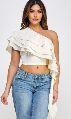 Ivory One shoulder asymmetrical top with ruffles Model in video in size small 34 Bust 26 Waist 5'1 Chic White Off-shoulder Top With Ruffles, White Tops With Asymmetrical Neckline For Spring, White Asymmetrical One Shoulder Top For Night Out, Chic One-shoulder Blouse With Ruffles, Spring Ruffled Off-shoulder Top For Night Out, Spring Off-shoulder Top With Ruffles For Night Out, Spring Asymmetrical Blouse With Ruffles, Spring Party One Shoulder Crop Top, Sleeveless Off-shoulder Top With Ruffles