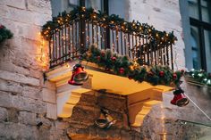 a balcony decorated with christmas lights and bells