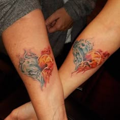 two people with matching tattoos on their arms