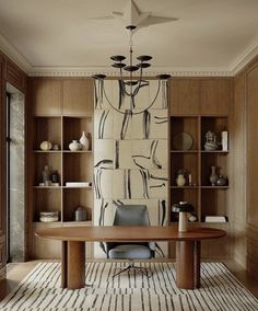 a room with a table, chairs and shelves filled with vases on the wall