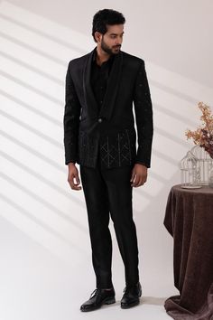 Black double lapel collar tuxedo with sequin and cutdana embroidery. Paired with a black shirt and pant.
Components: 3
Pattern: Embroidered
Type Of Work: Sequin, Cutdana
Neckline: Lapel collar
Sleeve Type: Long
Fabric: Terriwool and Cotton, Lining: Poly
Color: Black
Other Details: 
Attached poly lining
Approx. product weight: 3 kgs
Occasion: Cocktail and Reception - Aza Fashions Cutdana Embroidery, Tuxedo Pants, Tuxedos, Black Suits, Pant Set, Shirt And Pants, Lapel Collar, Aza Fashion, Sleeve Type