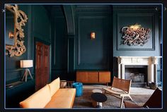 a living room filled with furniture and a fire place next to a wall mounted clock