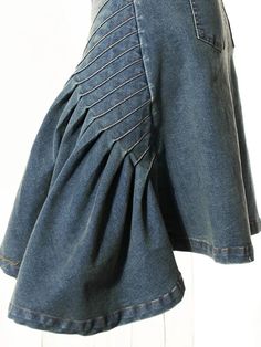 a woman's jean skirt with ruffles on the front and back sides