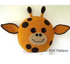 a crocheted giraffe purse with black spots on it's face