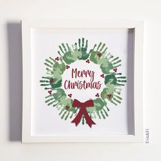 a handprinted christmas wreath with the words merry christmas in red, green and white