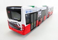 a red and white bus on a white surface