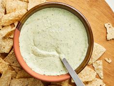 a bowl of dip surrounded by tortilla chips