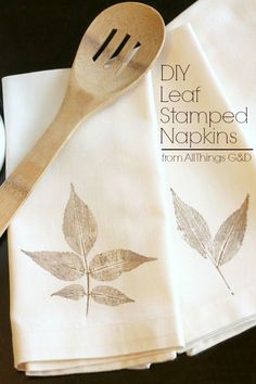 three napkins with leaves on them are next to a wooden spoon and cup that says diy leaf stamped napkins