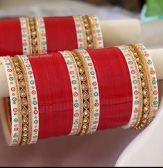 red and white bangles are sitting on a table