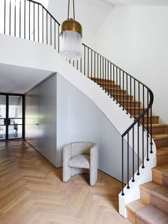 a staircase in a house with wooden floors and white walls