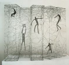 three wire sculptures depicting two people in the same area, one standing and one sitting