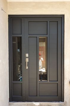 a black door with two glass panes on the front and side doors are closed