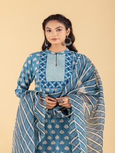 Blue dabu flower printed straight kurta, has a mandarin collar, mirror and katha embroidered yoke, three-quarter sleeves and stripes Print afgani Pants has Elasticated Waistband Fabric: 100% Cotton Color: Blue Note: Available in other colors Wash Care Instruction - Dry Clean Only The product will be shipped within 15-20 days of order placed Size Chart: Kurta Size XS S M L XL XXL XXXL Bust 36 38 40 42 44 46 Waist 32 34 36 38 40 42 Hip 38 40 42 44 46 48 Shoulder 14 14.5 15 15.5 16 16.5 Armhole 18 Festive Cotton Lawn Suit With Straight Kurta, Cotton Lawn Suit With Straight Kurta For Festive Season, Festive Unstitched Cotton Kurta, Festive Cotton Salwar Kameez Straight Kurta, Cotton Salwar Kameez Straight Kurta For Festive, Cotton Salwar Kameez Straight Kurta For Festive Occasions, Spring Indigo Cotton Kurta, Transitional Season Straight Kurta With Traditional Patterns, Bollywood Style Cotton Anarkali Set With Long Sleeves