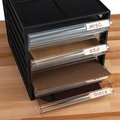 a stack of five drawers on top of a wooden floor