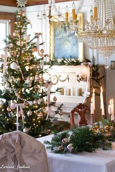 a dining room table with candles and christmas decorations