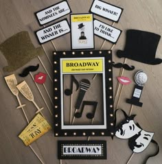 a bunch of props that are on top of a wooden table with the words broadway