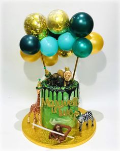 a birthday cake with balloons and animals on it